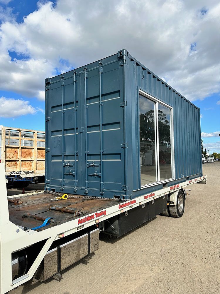 Modified container with glass sliding door on a truck