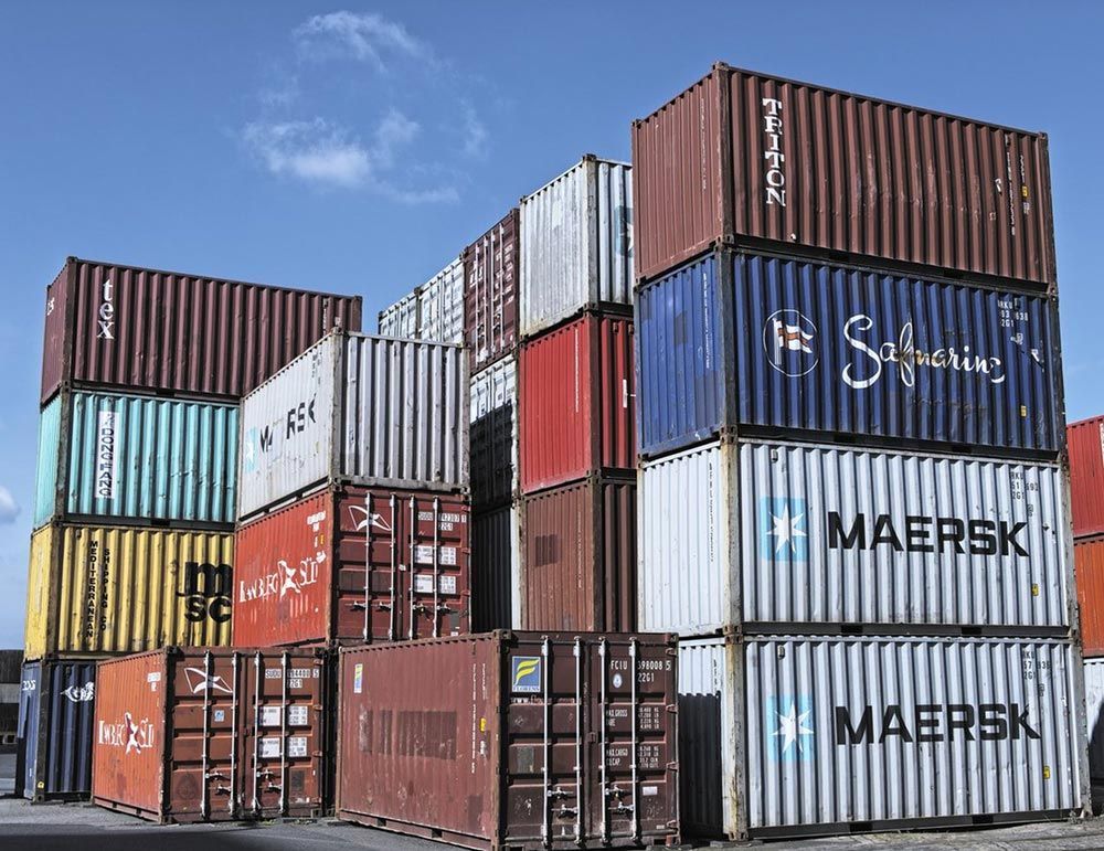Stacked used shipping containers in a container yard